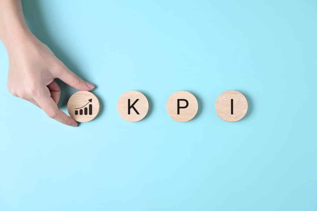 KPI, Key performance indicator, Businessman holding wooden cube with KPI icon, Business analysis KPI chart, Business goals, Target achievement