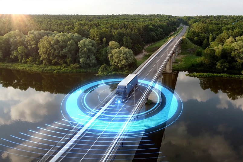 Illustration of a semi-truck driving over bridge, transmitting vehicle data in real time. 