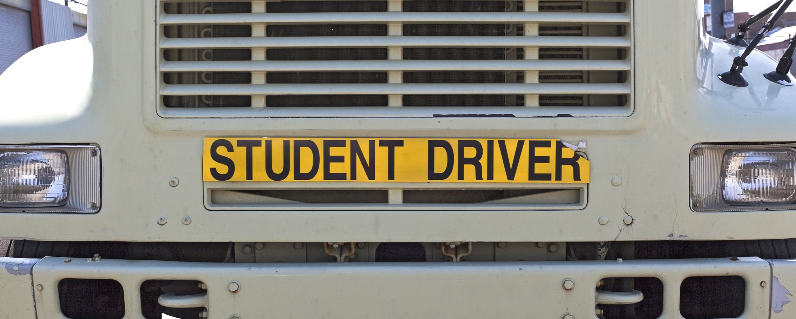Semi Truck with Student Driver sticker on front grill